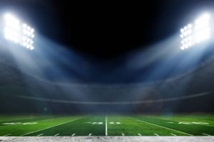 American football field illuminated by stadium lights